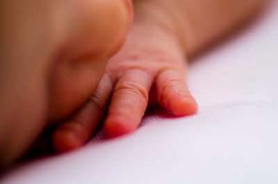 Close-up of baby sleeping on bed