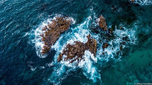 High angle view of rocks in sea