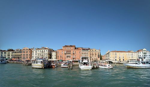 Boats in river with buildings in background