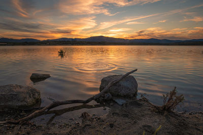 Scenic view of lake against sky during sunset