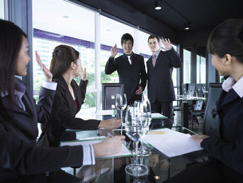 Smiling colleagues with drinks at restaurant during meeting