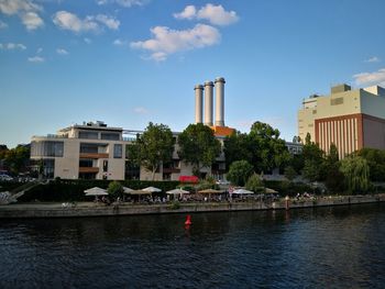 Buildings and trees against sky in city