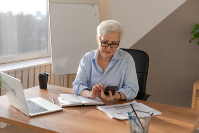 Young woman working at desk in office