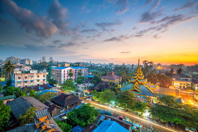 High angle view of buildings against cloudy sky