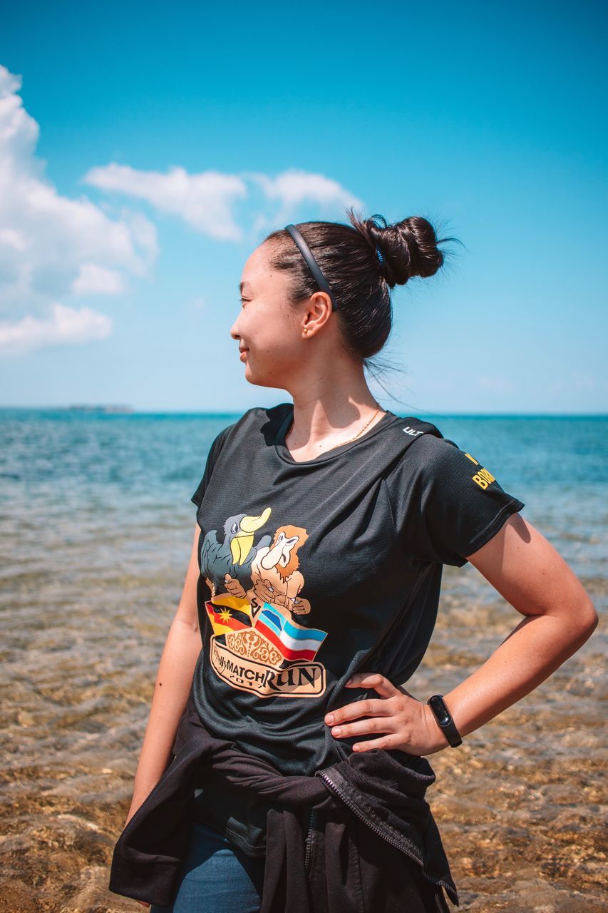 sea, water, sky, real people, lifestyles, land, one person, three quarter length, leisure activity, beach, casual clothing, horizon, horizon over water, nature, young adult, day, scenics - nature, beauty in nature, women, outdoors, hairstyle
