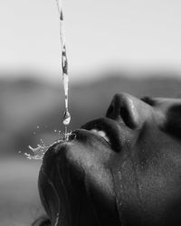 Close-up of water falling on woman face