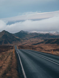 Empty road along countryside landscape