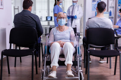 Rear view of people sitting on chair