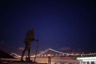 Low angle view of suspension bridge at night