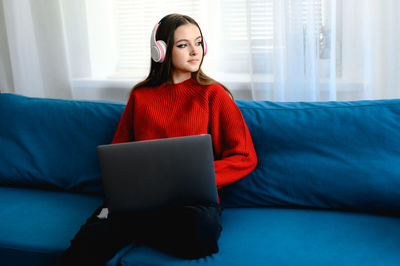 Young woman using laptop at home