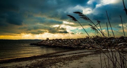 Scenic view of sea against cloudy sky