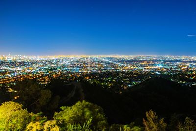 High angle view of illuminated buildings in city at night