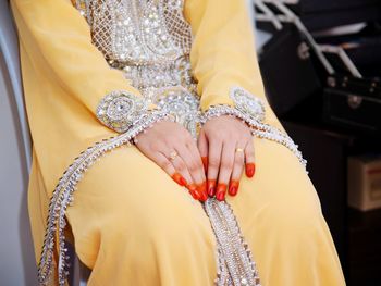 Midsection of bride sitting during wedding ceremony