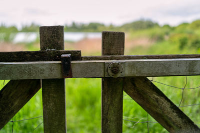 Close-up of rusty fence on field