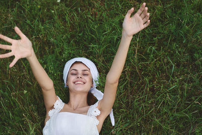 High angle view of young woman standing on grassy field