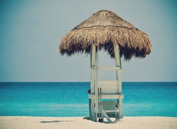 Lifeguard hut on beach against clear sky