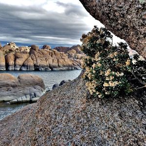 Scenic view of rocks in sea against sky