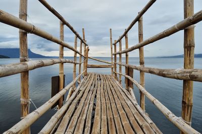 Close-up of pier over sea against sky