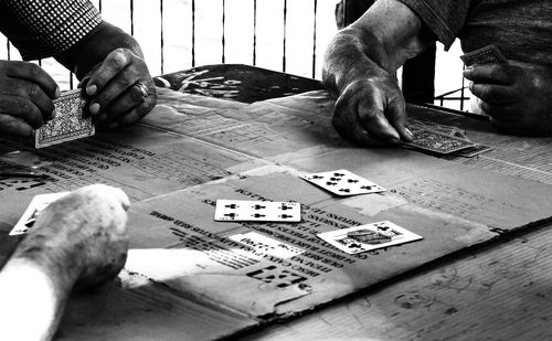 Rear view of man sitting on table