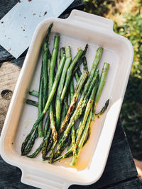 Bbq cookout backyard, grilled asparagus stalks in dish
