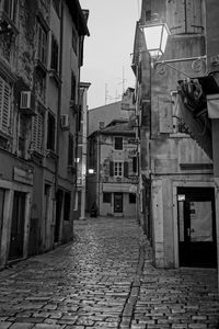 Narrow alley amidst buildings in city