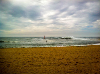 Scenic view of sea against cloudy sky