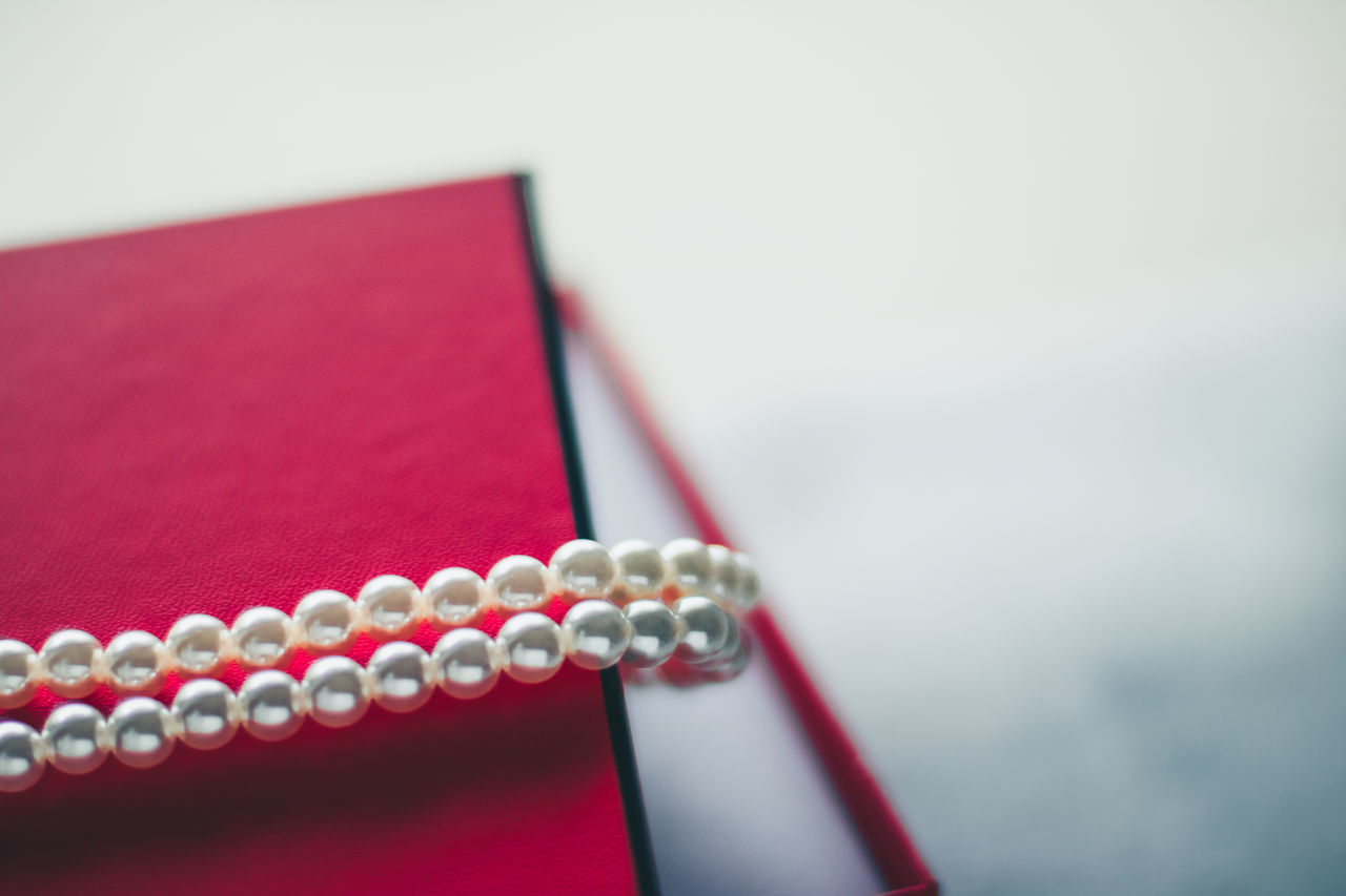 red, jewelry, pink, luxury, wealth, necklace, no people, fashion, close-up, studio shot, indoors, copy space, pearl jewelry, jewellery, personal accessory, fashion accessory, selective focus, elegance, still life