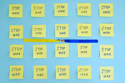 A lot of yellow stickers with words on blue background. concept of freedom and support.  stop war.