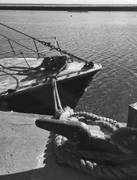 High angle view of rope tied to moored at harbor