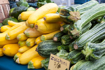 Yellow and green squash for sale at market stall