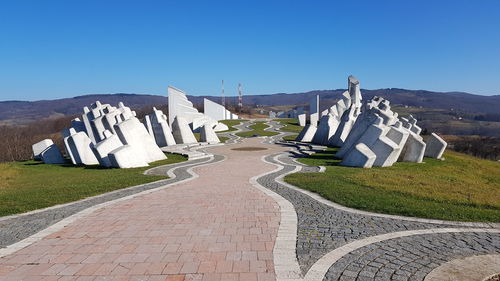 Panoramic view of footpath against blue sky