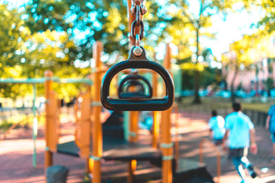 Metallic handles by boys at playground