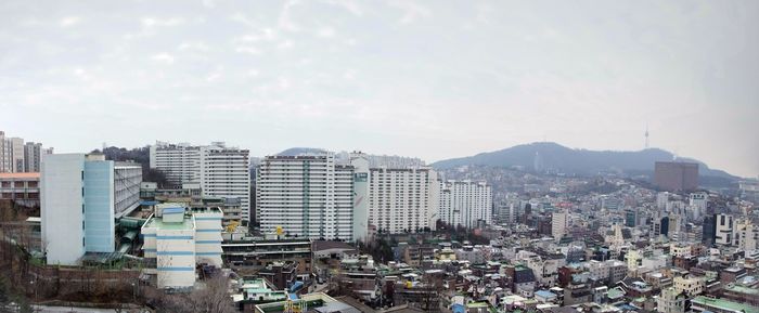 High angle view of buildings in city against sky