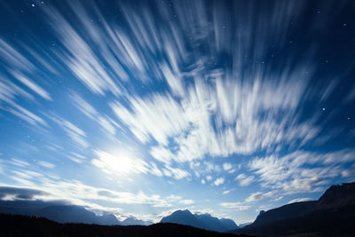 Scenic view of silhouette mountains against sky at night