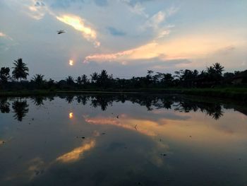 Scenic view of lake against sky during sunset