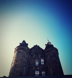 Low angle view of historic building against clear blue sky