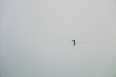 Man in lake during winter