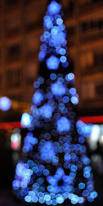 Close-up of illuminated christmas tree against sky