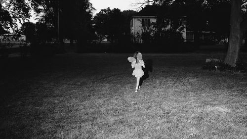 Full length of woman walking on field