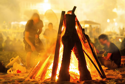 People in traditional clothing at night