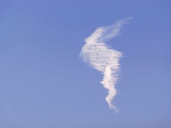 Low angle view of vapor trail against clear blue sky