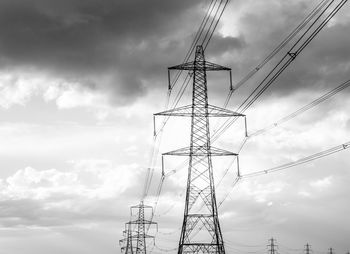 Low angle view of electricity pylon against sky