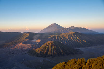 Scenic view of volcanic landscape against sky during sunset