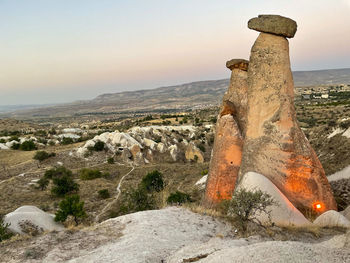 Scenic view of rocks against sky during sunset