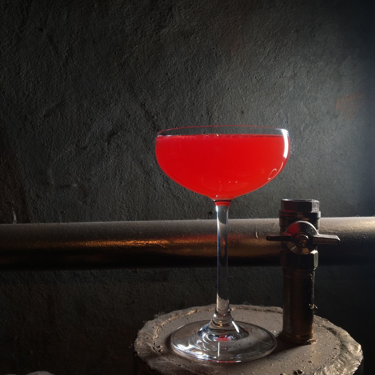 CLOSE-UP OF RED WINE GLASS ON TABLE