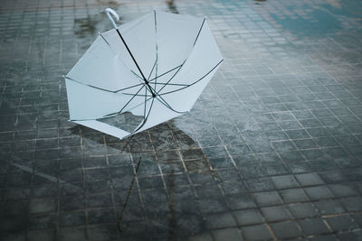 High angle view of broken umbrella on footpath