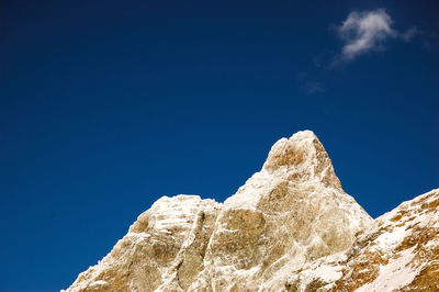 Low angle view of rock formations against blue sky