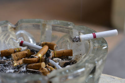 Close-up of cigarette smoking on table