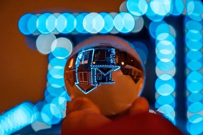 Close-up of hand holding illuminated lighting equipment