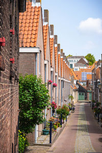 Empty footpath by residential buildings in city